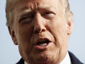 President Donald Trump talks to media before boarding Marine One on the South Lawn of the White House in Washington, Saturday, Dec. 8, 2018.