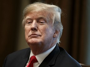 In this Dec. 13, 2018, file photo, President Donald Trump listens during a meeting in the Cabinet Room of the White House in Washington. New York Attorney General Barbara Underwood and Trump’s charitable foundation reached a deal on Tuesday, Dec. 18, 2018, to dissolve the foundation and distribute its remaining assets to other nonprofit groups.