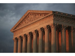 In this Oct. 4, 2018 photo, the U.S. Supreme Court is seen at sunset in Washington. The Supreme Court is avoiding a high-profile case by rejecting appeals from Kansas and Louisiana in their effort to strip Medicaid money from Planned Parenthood over the dissenting votes of three justices.