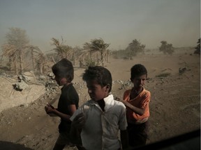 FILE - In this photo, homeless children stand on the road from Khoukha to Taiz in Yemen. Envoys from Yemen's warring parties are headed to Sweden for another round of peace talks to stop the three-year-old war, but with few incentives to compromise, expectations are low for little more than improving a faltering de-escalation.