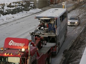 The OC Transpo bus involved in Friday's crash at Westboro Station was towed from the scene, revealing extensive damage, on Jan. 12, 2019. (David Kawai)