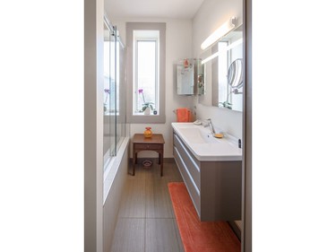 Much like the rest of the transformed home, bright details pop against the majority-white interior. The bathroom continues the modern trend found in the home.