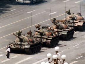 In this iconic June 5, 1989 file photo, a Chinese man stands alone to block a line of tanks heading east on Beijing's Cangan Boulevard in Tiananmen Square.  The pro-democracy protests in the square were squashed by the Chinese government.