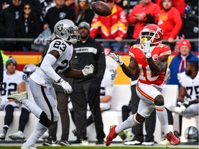 Tyreek Hill of the Kansas City Chiefs catches a pass in front of Nick Nelson of the Oakland Raiders on Dec. 30, 2018.