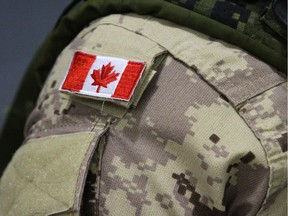 A flag on the uniform of a member of the Canadian forces.