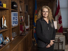 Governor General Julie Payette stands next to a shelf featuring memorabilia from her career as an astronaut, in her office at Rideau Hall.