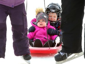 Nolan McDougall, 4, keeps his little sister Mila, 1, safe as they got pulled behind their dad and older sister Tuesday (Jan 1, 2018). A stretch of the Rideau Canal skateway was open New Years Day (from Bank Street to Pretoria Bridge) and drew some hearty souls to enjoy the sunshine, but also some patchy ice.