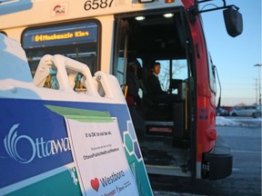 Bus stop at the OC Transpo park and ride at Eagleson Road on Monday morning. A sign guides people to where they can go if they need help or counselling. (Photo by Jean Levac/Postmedia News)