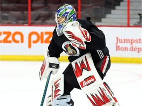 Anders Nilsson shows off new Senators-colour pads during practice on Tuesday.