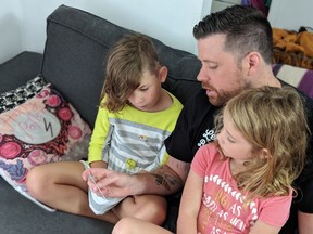 Mike Reynolds with his two daughters, Leah, 9, left, and Charlotte, 6.