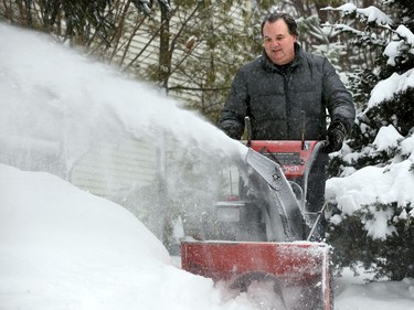 Stittsville's Gary Driver digs out with his snowblower.