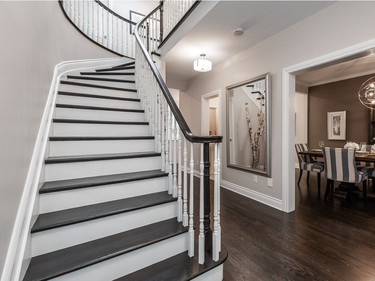The elegant staircase has white risers and a dark wooden banister which give the home a contemporary feeling. The white risers were added to make the staircase feel less heavy.