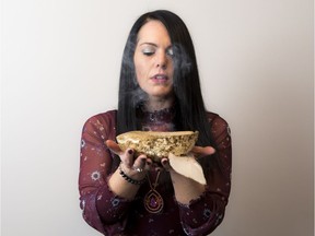 Brooke Stratton, a social worker/advocate for the Ontario Native Women's Association, demonstrates smudging at her Ottawa home.