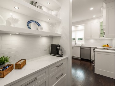 The charming coffee bar was added to the rear of the full-height pantry to decrease clutter on the main kitchen counters. Previously, there was a clunky and awkward angled lower cabinet that wrapped around a tight corner.