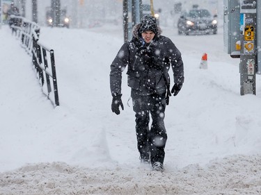 Pedestrians navigate the snow streets along Montreal Rd.