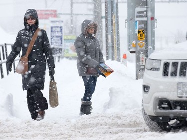 Pedestrians navigate the snow streets along Montreal Rd. Photo by Wayne Cuddington/ Postmedia