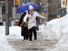 Sidewalks were covered in heavy slush and slippery as the capital's dump of snow Wednesday turned into freezing rain Thursday.