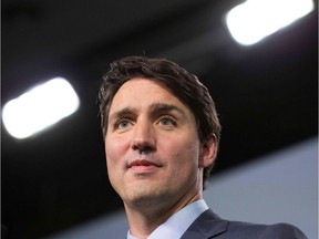 (FILES) In this file photo taken on June 09, 2018 Canadian Prime Minister Justin Trudeau addresses a press conference at the conclusion of the G7 summit in La Malbaie, Quebec. - Canadian Prime Minister Justin Trudeau reshuffled his cabinet on January 14, 2019 ahead of upcoming elections, naming a new attorney general who could decide the fate of a Chinese executive arrested in a case that has roiled Ottawa's relations with Beijing. Yale-educated former law professor David Lametti was one of two new ministers named in the shake-up, likely the last significant change to Trudeau's team before Canadians head to the polls in October.