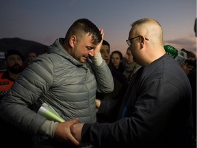 Jose Rosello (L), father of Julen who fell down a well, cries as rescue efforts continue to find the boy in Totalan in southern Spain on January 16, 2019. - Rescuers racing to save a two-year-old boy who fell down a well in southern Spain have found several strands of his hair, authorities said, raising hopes of finding the toddler whose fate has gripped the nation for days. It is the first confirmation that Julen is down the 110-metre (360-foot) deep shaft after family members said he tumbled in while playing as his parents had lunch nearby.