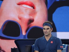 Switzerland's Roger Federer waits in his chair during a break in his third round match against United States' Taylor Fritz at the Australian Open tennis championships in Melbourne, Australia, Friday, Jan. 18, 2019.