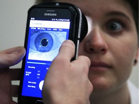 Clinical Research Assistant Kevin Jackson uses AlgometRx Platform Technology on Sarah Taylor's eyes to measure her degree of pain at the Children's National Medical Center in Washington, Monday, Dec. 10, 2018. Children's National Medical Center is testing an experimental device that aims to measure pain according to how pupils react to certain stimuli.