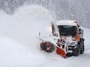 A snow plow cleans a road.