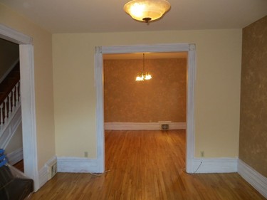 BEFORE: Like many homes of its age, there was no open-concept layout. Instead many walls strictly defined the rooms. This entryway is between the former living and dining area.