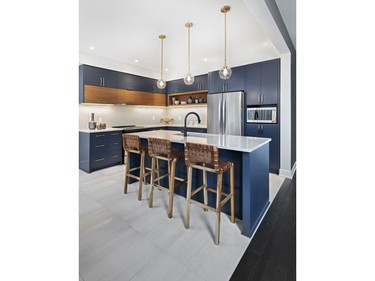 The on-trend blue kitchen in the Colvin features a roomy island and flat-panel cabinets, in keeping with the contemporary flavour of the homes.