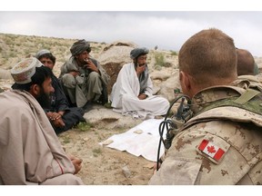 Members of the Afghan National Police (ANP) are seen at a shura (meeting) with soldiers from the Canadian Forces in Kandahar, southern Afghanistan, 20 April 2006. Our military has taken steps to help soldiers with PTSD, but stigma remains.