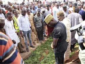 In this photo taken Friday, Jan. 18, mourners bury the body of Ahmed Hussein-Suale, investigative journalist, who was shot dead by gunmen on a motorbike on Wednesday night, in Accra, Ghana.
