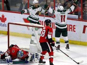 The Minnesota Wild's Zack Parise (11) celebrates his goal against the Ottawa Senators with teammate Charlie Coyle (3) as Senators goaltender Anders Nilsson (31) and Maxime Lajoie react during the third period in Ottawa on Saturday, Jan. 5, 2019.