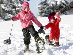 Emi Johnson, 5, and her sister Sadie, 2, have some fun snowshoeing.