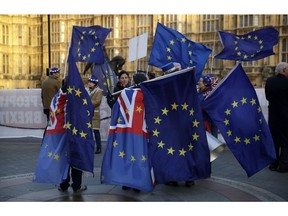 Pro-Europe demonstrators hold banners and flags outside the Houses of Parliament in London, Tuesday Jan. 8, 2019. The British government on Tuesday ruled out seeking an extension to the two-year period taking the country out of the European Union ahead of a crucial parliamentary vote next week on Prime Minister Theresa May's Brexit deal.