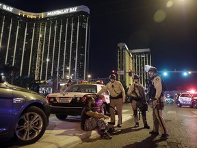 A file photo from Oct. 1, 2017, shows Las Vegas police officers standing at the scene of a shooting near the Mandalay Bay resort and casino. After nearly 16 months, the FBI says it can't determine why gunman Stephen Paddock killed 58 people and injured nearly 900 others in the attack.