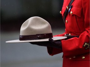 A RCMP officer holds a stetson in honour of Const. Sarah Beckett during a regimental funeral service at the Q Centre arena in Colwood, B.C. on April 12, 2016. The man who was drunk and speeding when he rammed a police car, killing the officer inside, will be sentenced by a court near Victoria today. The court heard during Kenneth Fenton's sentencing hearing in June that he had a blood-alcohol level three times the legal limit when he ran a red light in his truck, hitting Const. Sarah Beckett's cruiser broadside.