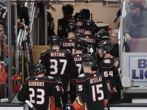 Ducks players leave the ice after their 4-0 loss to the Oilers in Anaheim on Sunday night.