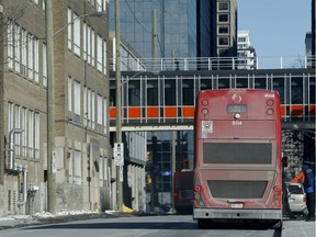 An OC Transpo double decker bus rolls along a downtown Ottawa street on Thursday.