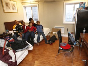 A family in the Ottawa Inn Hotel on Dec 18, 2018. Temitope Adesina, his wife Andesina and their three kids Mogboluwaga (11), Mogbotoluwa (8) and Ethan (4) sit in their room Tuesday.