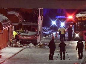 Police and a first responders work at the scene where a double-decker city bus struck a transit shelter in Ottawa, on Friday, Jan. 11, 2019.