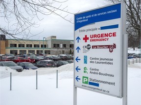 Some of the English words on the sign at the regional hospital have been covered Wednesday, January 9, 2019 in Lachute, Que. Administrators of the hospital 80 kilometres northwest of Montreal announced they would eliminate the English signs that have been posted for years, in order to comply with Quebec's language law, Bill 101.