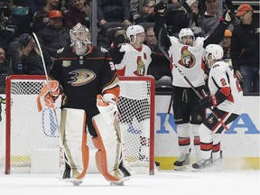 The Ottawa Senators' Colin White, second from right, celebrates his game-winning goal against Anaheim Ducks goaltender John Gibson, left, alongside teammates Dylan DeMelo (2) and Mark Stone, second from left, during overtime on Wednesday, Jan. 9, 2019, in Anaheim, Calif. Ottawa won 2-1.