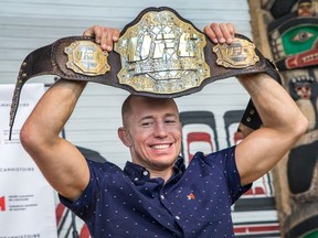 UFC Champion Georges St-Pierre shows off the 2009 Ultimate Fighting Championship title belt that the Canadian Museum of History has acquired and which will become part of the permanent exhibition.
