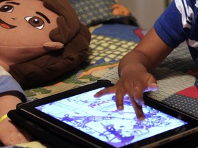 FILE: A child uses a tablet.