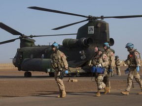 Canadian soldiers carry a stretcher to a waiting ambulance during a medical evacuation demonstration on the United Nations base in Gao, Mali, Saturday, December 22, 2018.