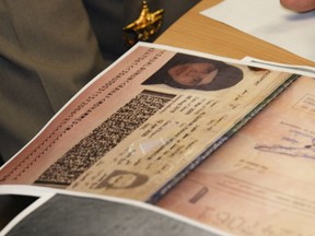 A passport copy of Rahaf Mohammed Alqunun sits on the desk as Chief of Immigration Police Maj. Gen. Surachate Hakparn talks to media about her status during a press conference at the Suvarnabhumi Airport in Bangkok Monday, Jan. 7, 2019. Thailand's Immigration Police chief says Alqunun, the young Saudi woman stopped in Bangkok as she was trying to escape alleged abuse by her family by traveling to Australia for asylum, will not be sent anywhere against her wishes.