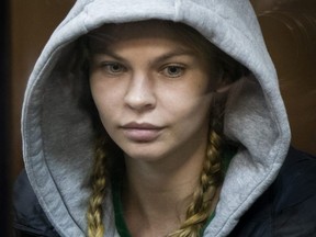 Anastasia Vashukevich, also known on social media as Nastya Rybka, sits in a cage in a Moscow courtroom, Saturday, Jan. 19, 2019.