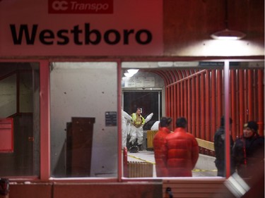 Firefighters put on protective suits before attending the scene as first responders attend to victims of a horrific rush hour bus crash at the Westboro Station near Tunney's Pasture.