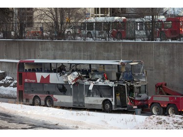 The OC Transpo bus involved in Friday's crash at Westboro Station was towed from the scene, revealing extensive damage, on Jan. 12, 2019.