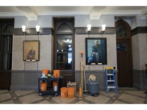 Portraits of past prime ministers Lester B. Pearson and Pierre Elliot Trudeau hang on the walls as cleaning items stand ready in the lobby of the temporary House of Commons in preparation for the opening of Parliament after the Christmas break as Centre Block closes for a minimum of 10 years for renovations, in Ottawa on Sunday, Jan. 27, 2019.