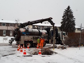 City workers at scene of gas and water line break in Blackburn Hamlet.